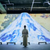 Visiteur face à une projection immersive du mont Fuji dans l’exposition Passion Japon à Paris.