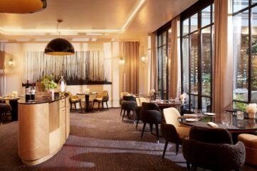 Salle du restaurant Le Baudelaire au Burgundy Paris, baies vitrées ouvertes sur le patio