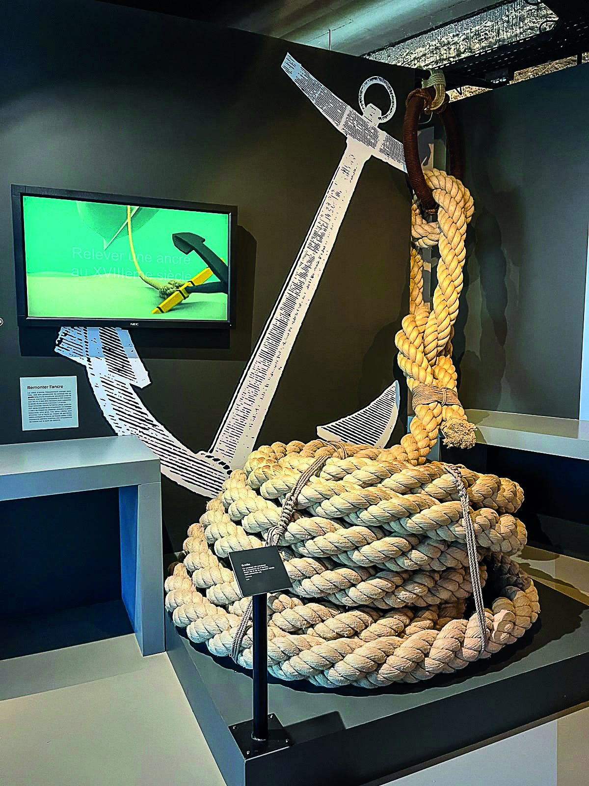 Gros cordage enroulé autour d'une ancre, exposé à la Corderie royale